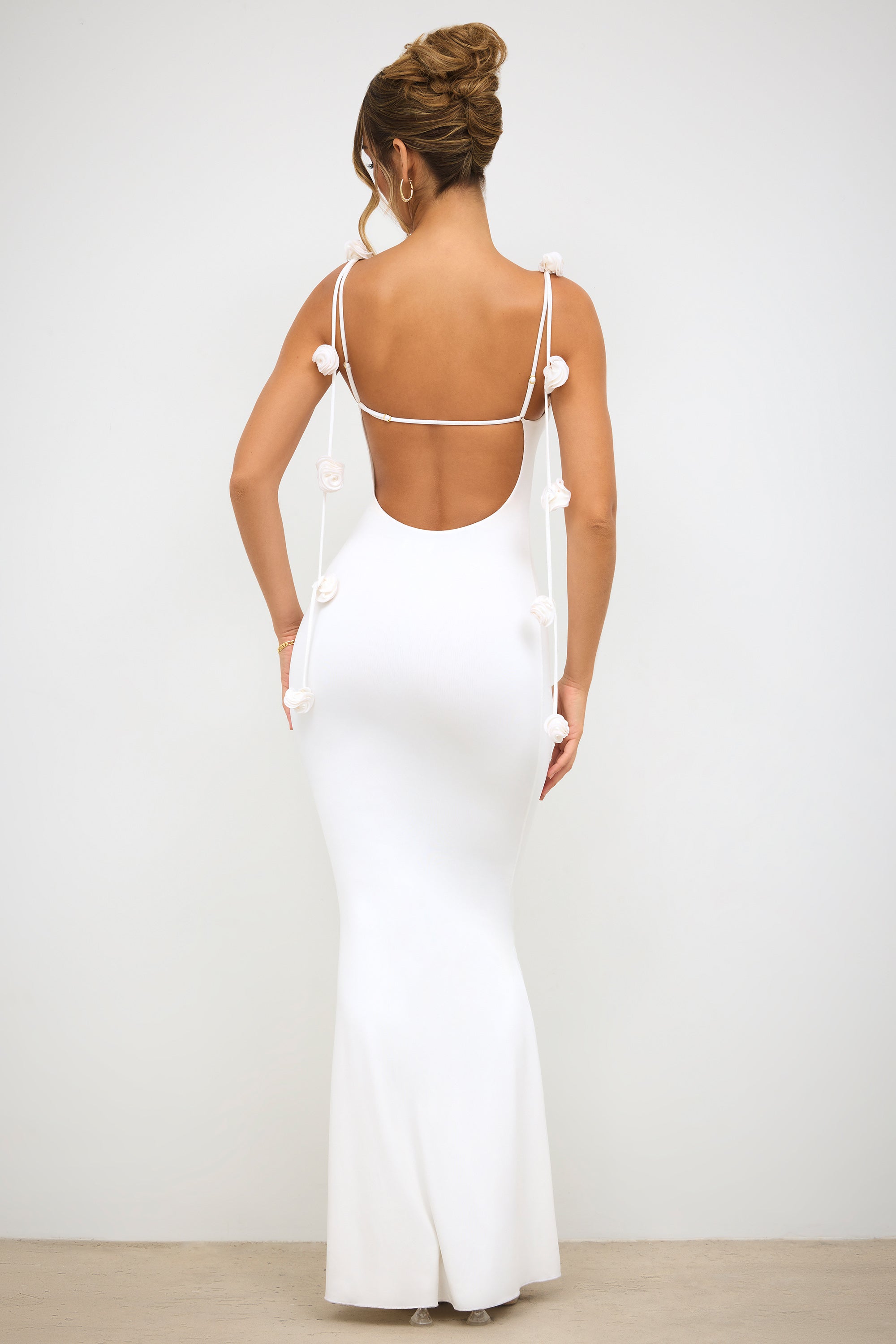 Rose-accented white evening gown